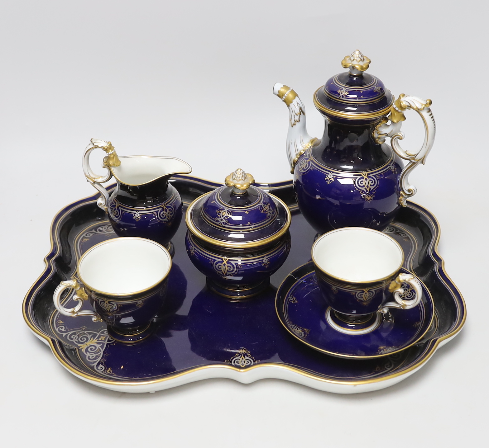 A late 19th century Meissen cabaret set comprising sugar bowl and cover, teapot and cover, creamer, two cups, a saucer and a tray (a.f.)